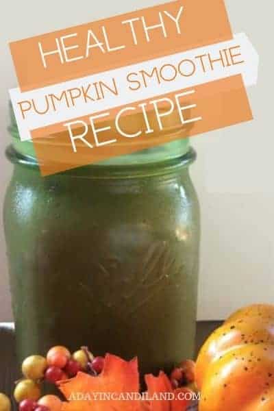 Green glass of pumpkin smoothie on table