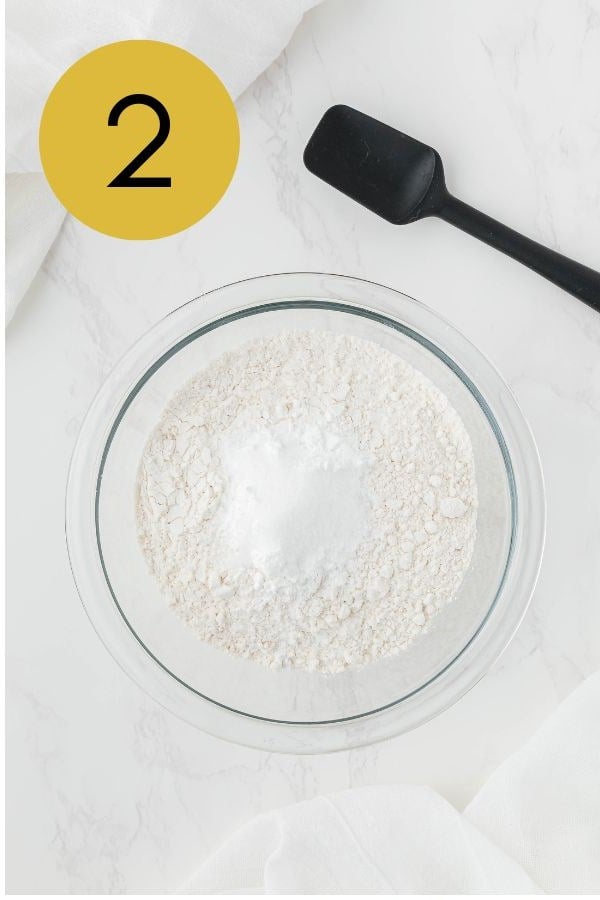 The baking powder and salt added on top of the flour, ready to stir.