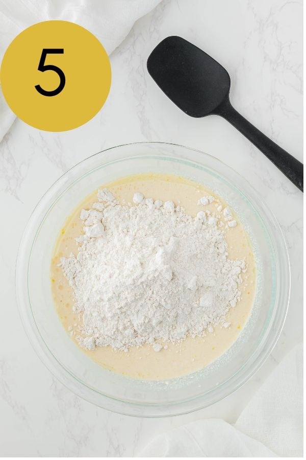 The flour mixture added into the bowl of wet ingredients.