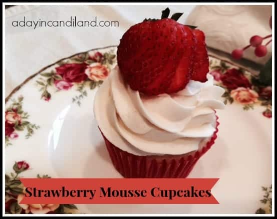 Strawberry Cupcakes with filling on a china plate with a sliced strawberry on top