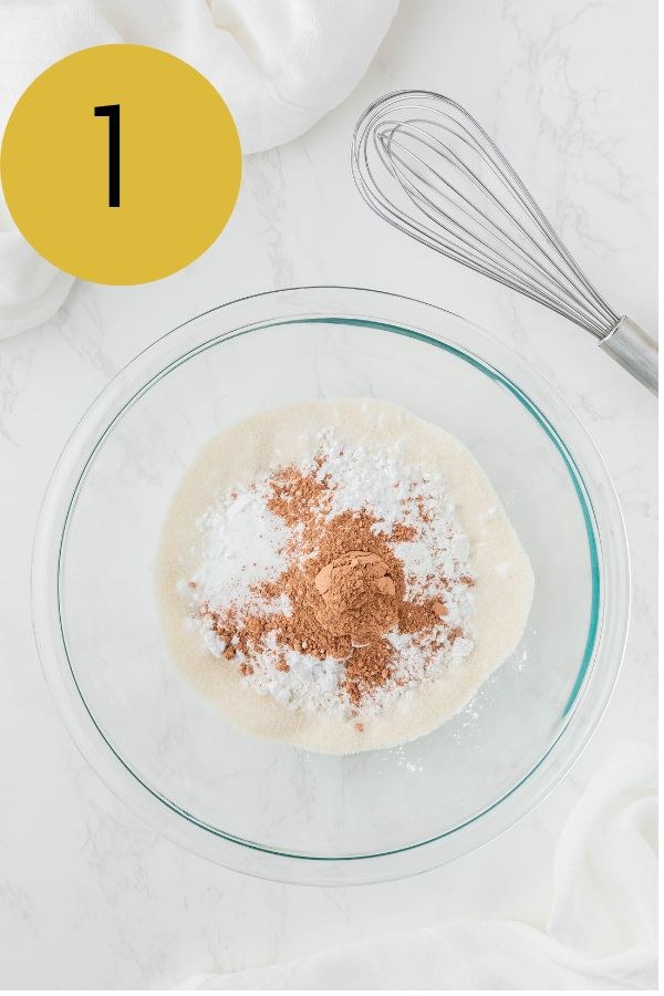 Cocoa powder, baking powder, sugars, flour and salt in a glass mixing bowl.