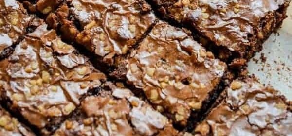 Chocolate brownies with chopped nuts cut into squares.