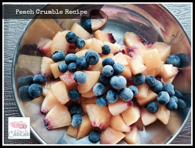 Chopped peaches and blueberries in dish for peach cobbler