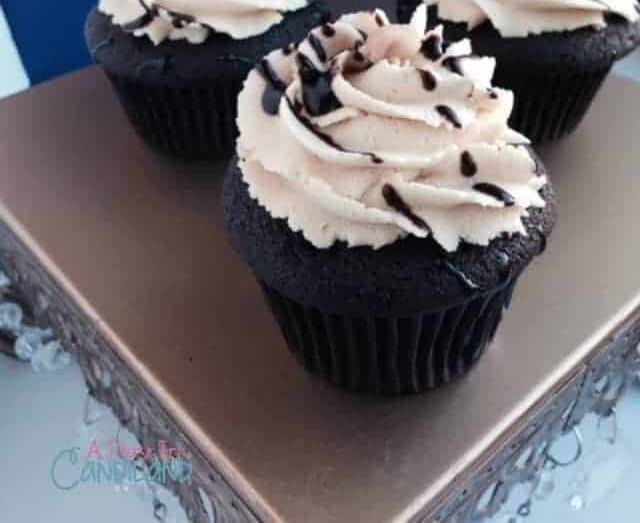 Close up of a dark chocolate cupcake with swirled peanut butter frosting and a chocolate drizzle.