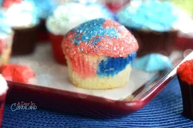 Red White and Blue cupcakes with sprinkles and patriotic cupcake flags. 