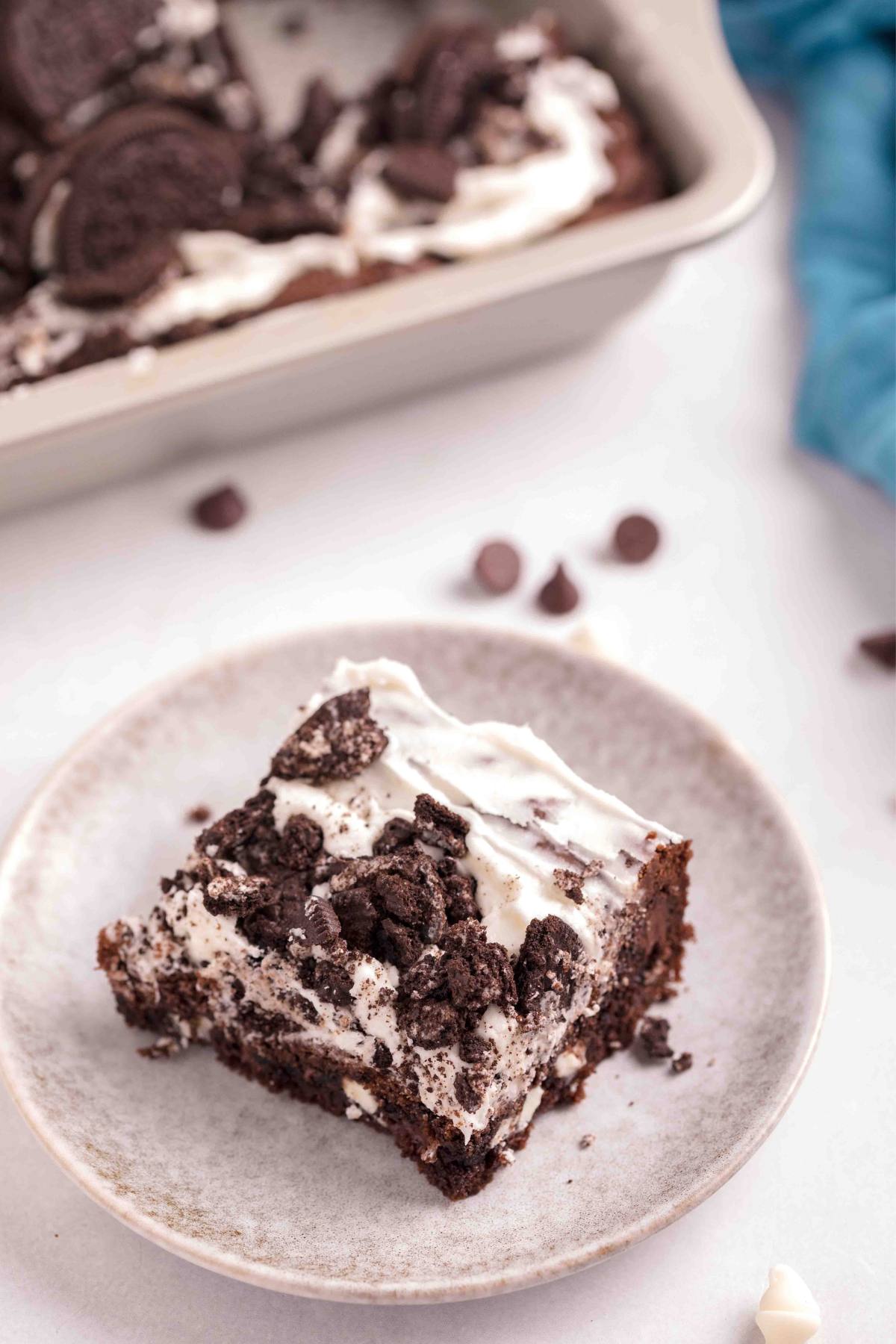 Pan of Cookies and Cream Brownies with a plate of a slice of brownies.