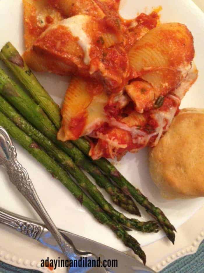 Stuffed jumbo shells, asparagus on plate to feed a large family dinner