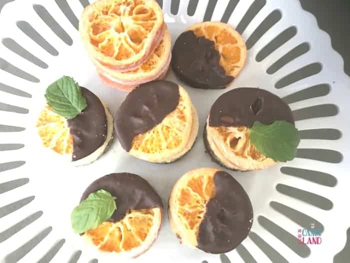 Mini Orange Cheesecakes with Chocolate Dipped Candied Oranges and a sprig of mint