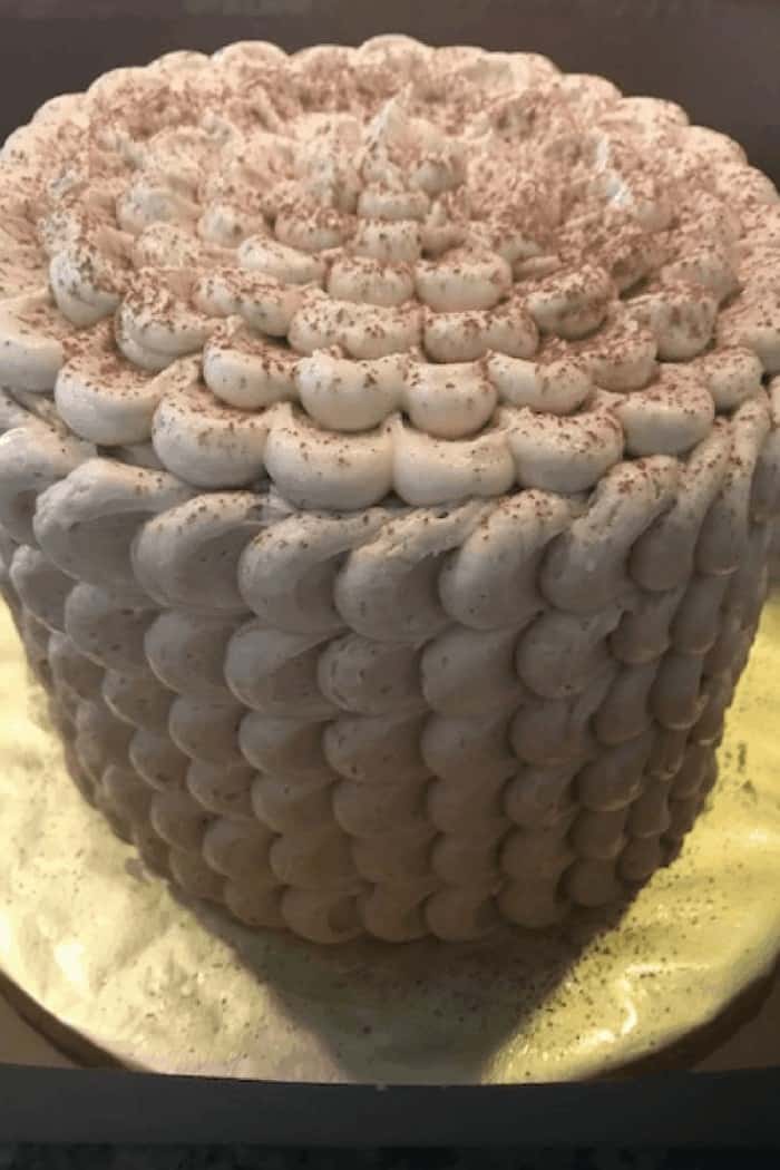 Side view of the tiramisu cake with rows of spoon swiped espresso buttercream petals.