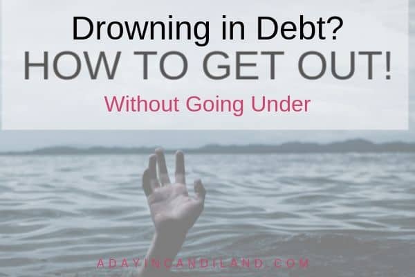 Drowning in debt with hand coming out of the ocean