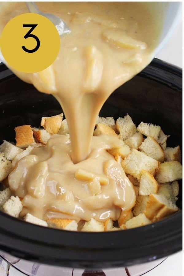 The creamy apple custard poured over the bread cubes in the crockpot.
