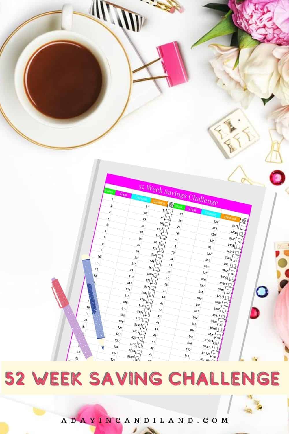 Desk with printable 52 week savings challenge sheet on it.