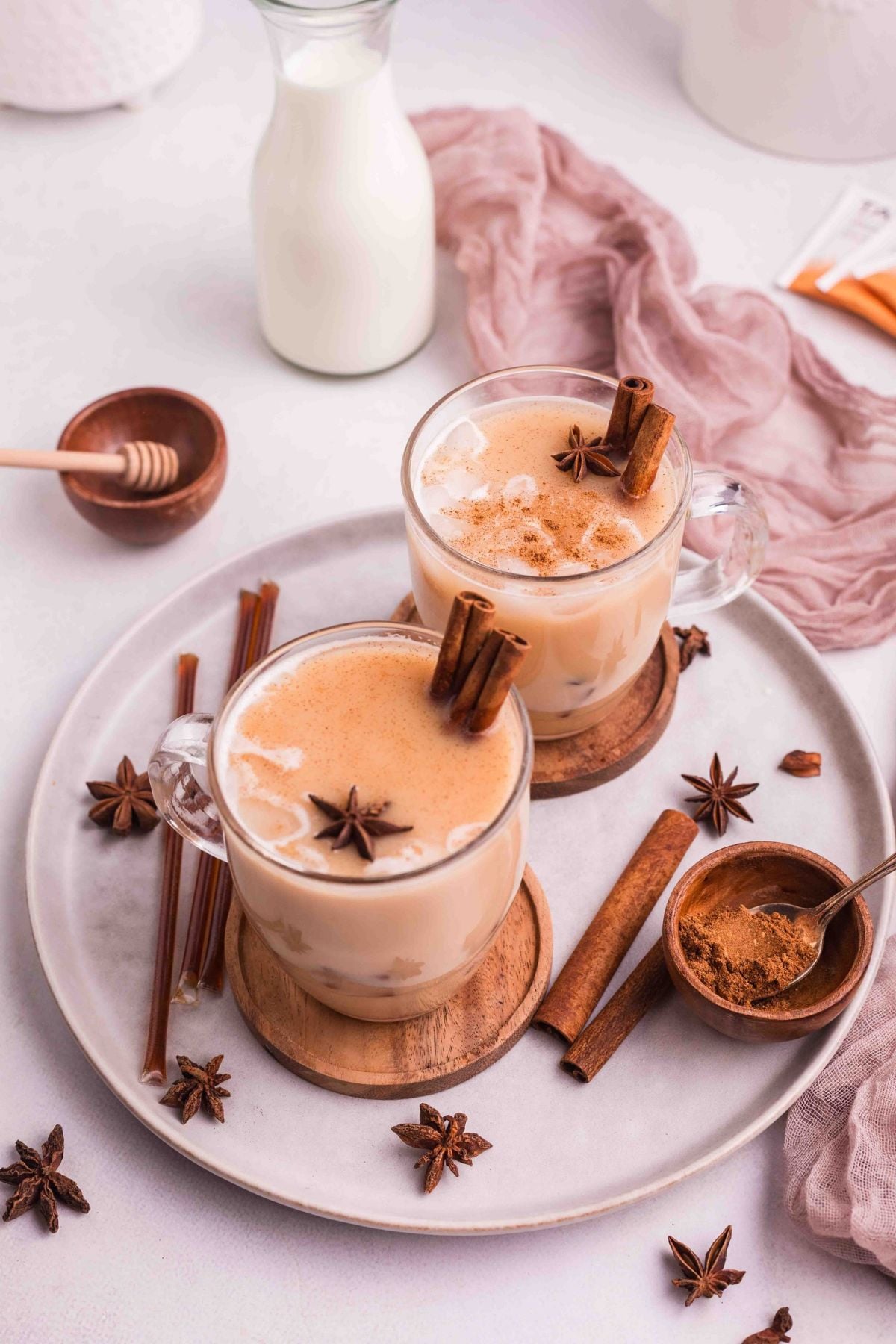 Chai Tea in a two mugs with star anise and cinnamon sticks.