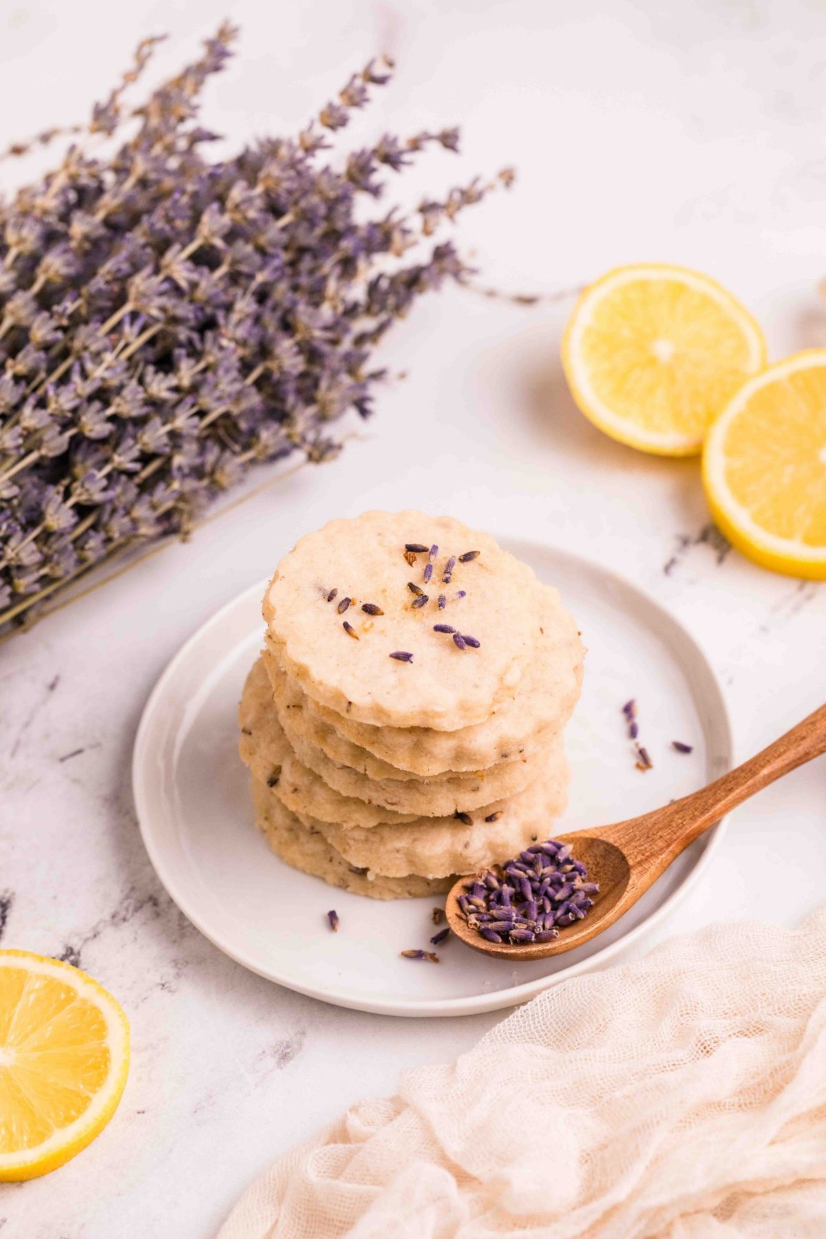 Plate of Lemon Lavender Cookies, with a sprig of lavender stems.