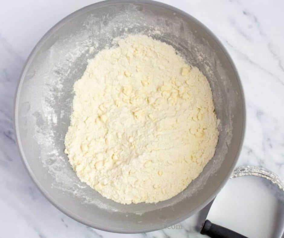 The butter cut into the flour until the mixture looks like coarse crumbs.