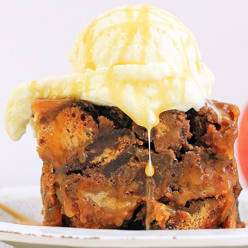 Slice of Bread Pudding with a scoop of ice cream on top