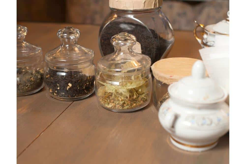 Clear jars of loose leaf tea. 