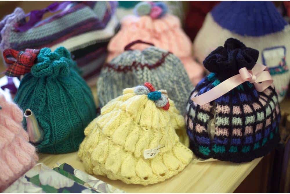 8 different knitted tea cozies. 