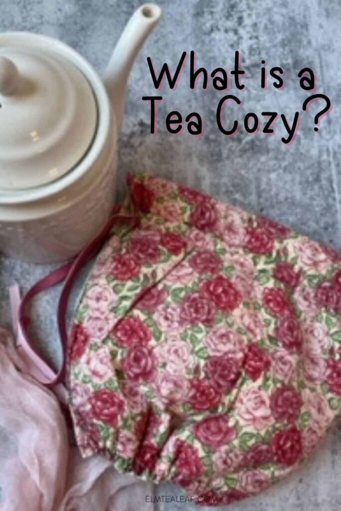 White Tea pot and Floral Tea Cozy next to it. 
