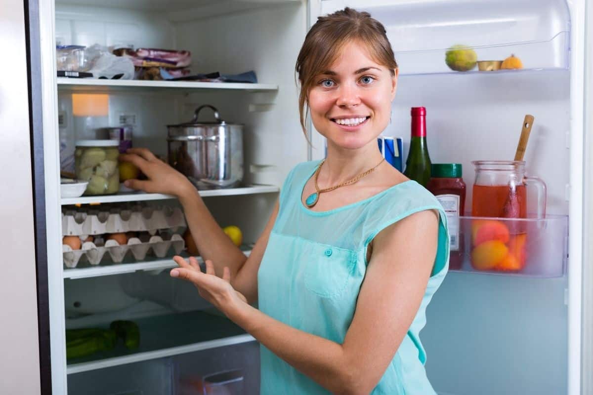 Does Brewed Tea Go Bad. A lady looking into her refrigerator. 