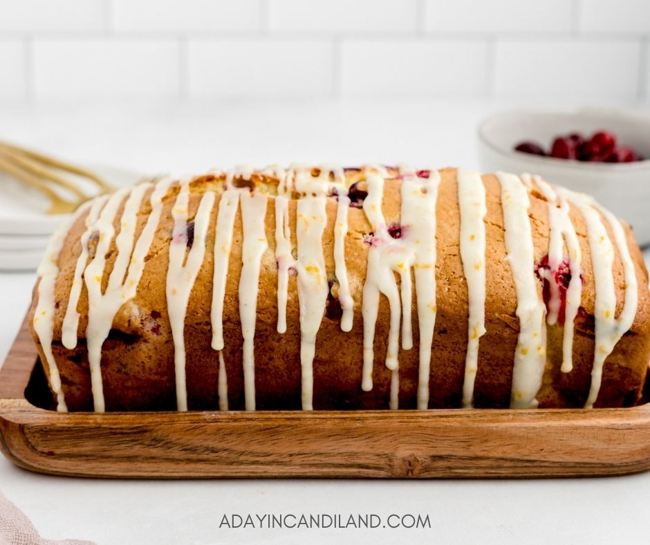 Full Cranberry Orange Loaf on a wooden tray. 