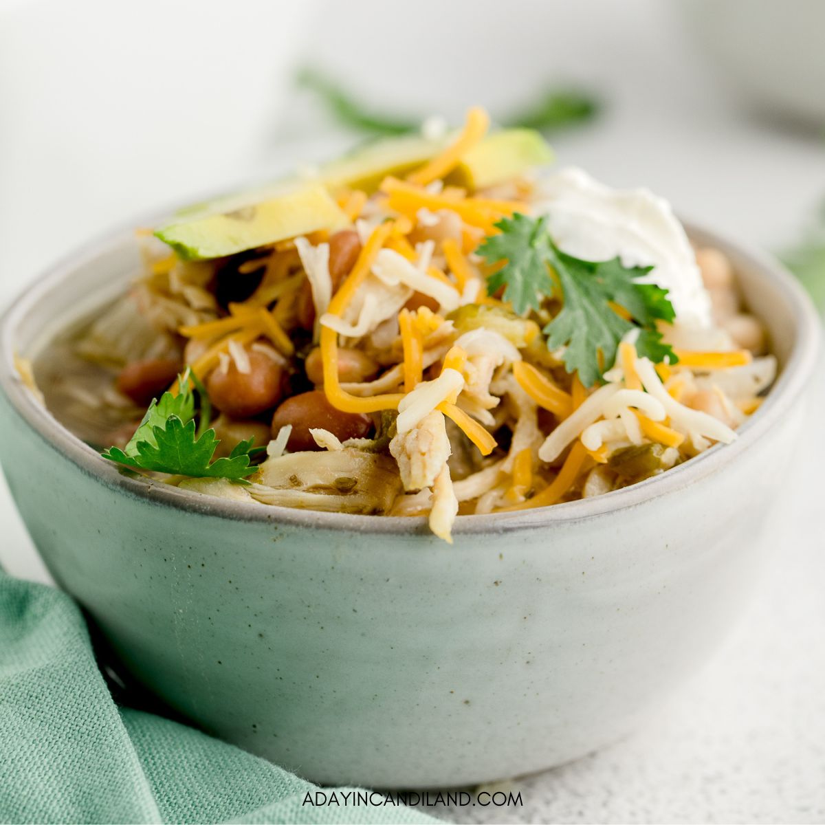 Bowl of White Chili on a table with a napkin. 