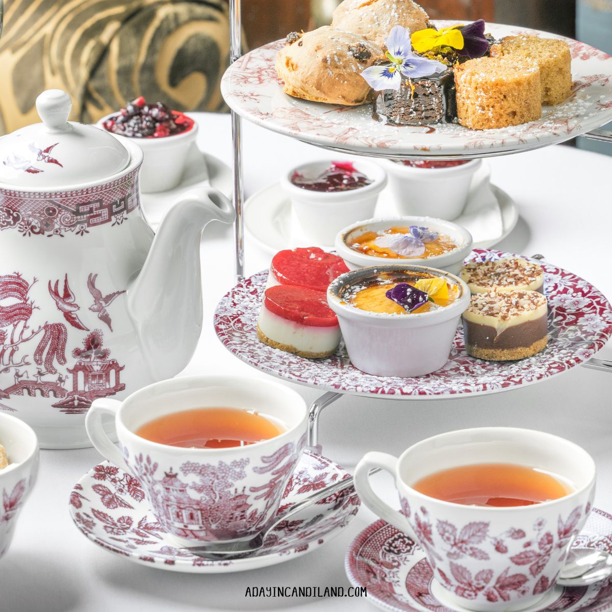 Table set for Afternoon Tea with tea, treats and teacups. 