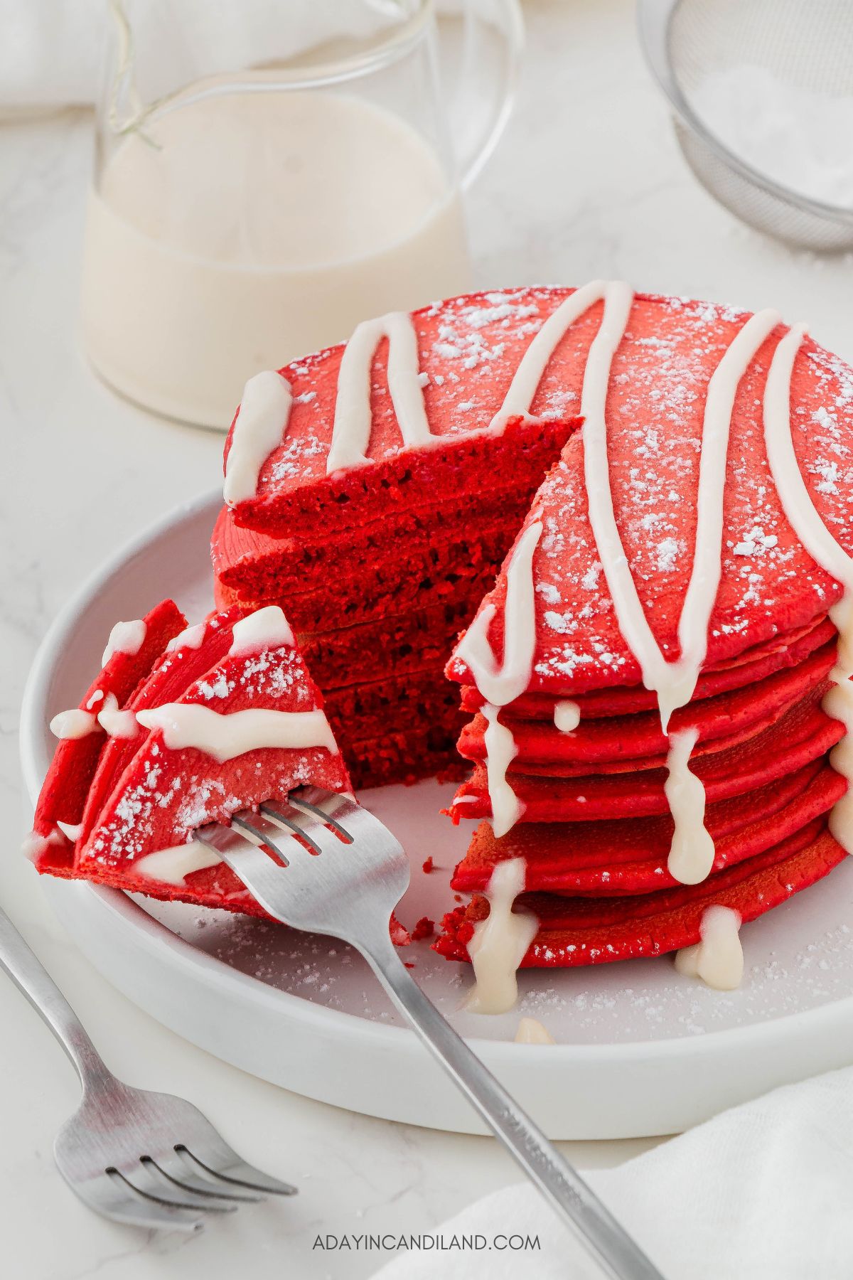 Plate of Red Velvet Pancakes with Slice or Bite taken out with a fork. 