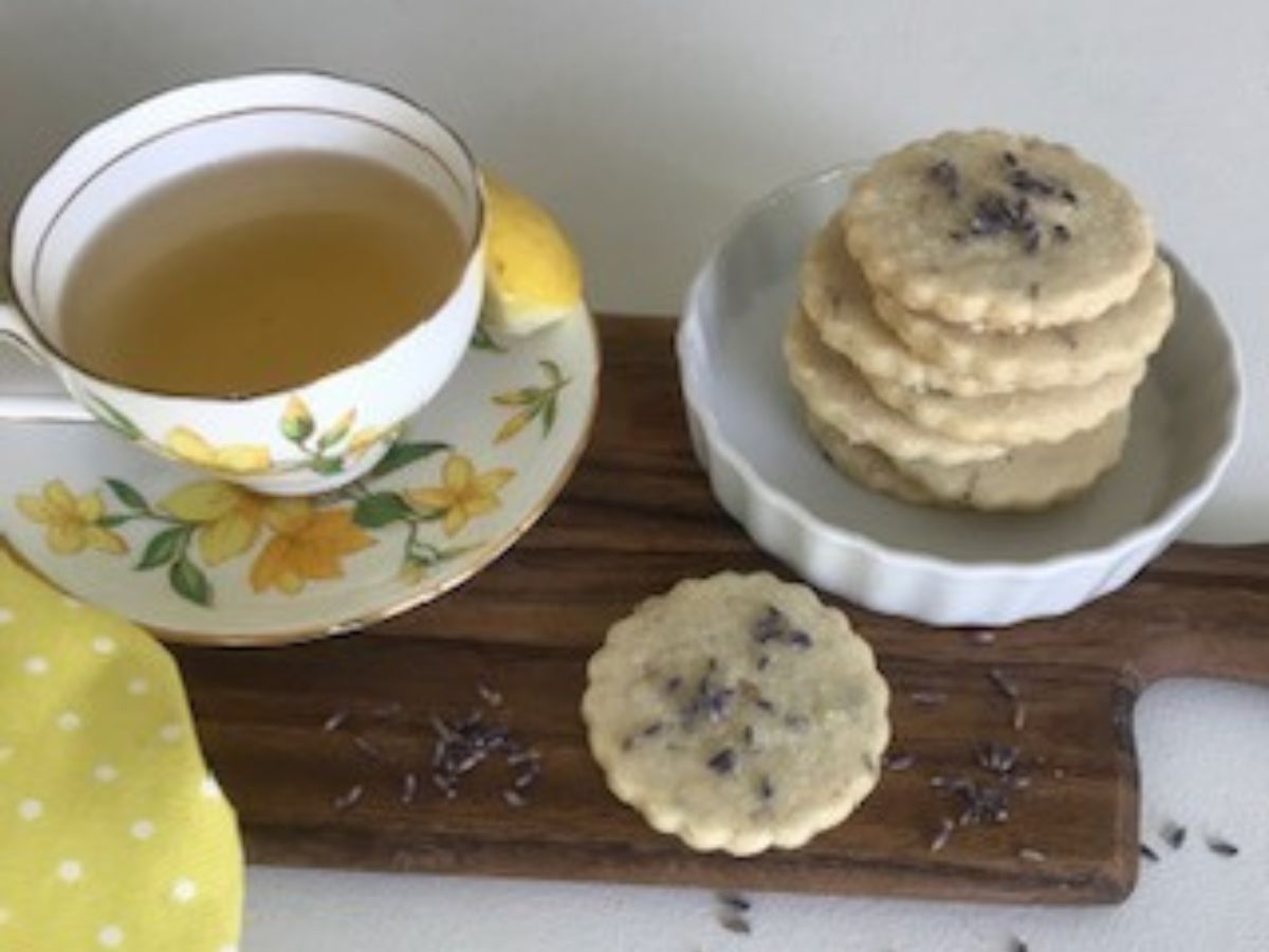 Lemon Lavender Cookies and a cup of tea on the table. 