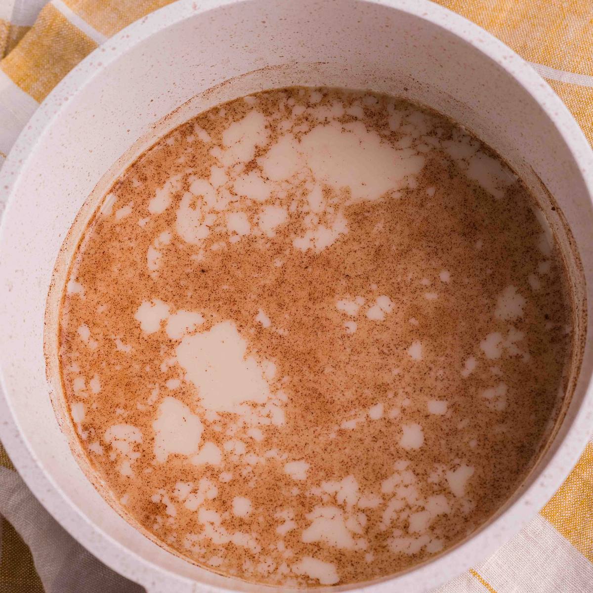 Milk, honey and cinnamon warming with the chai tea in the saucepan.
