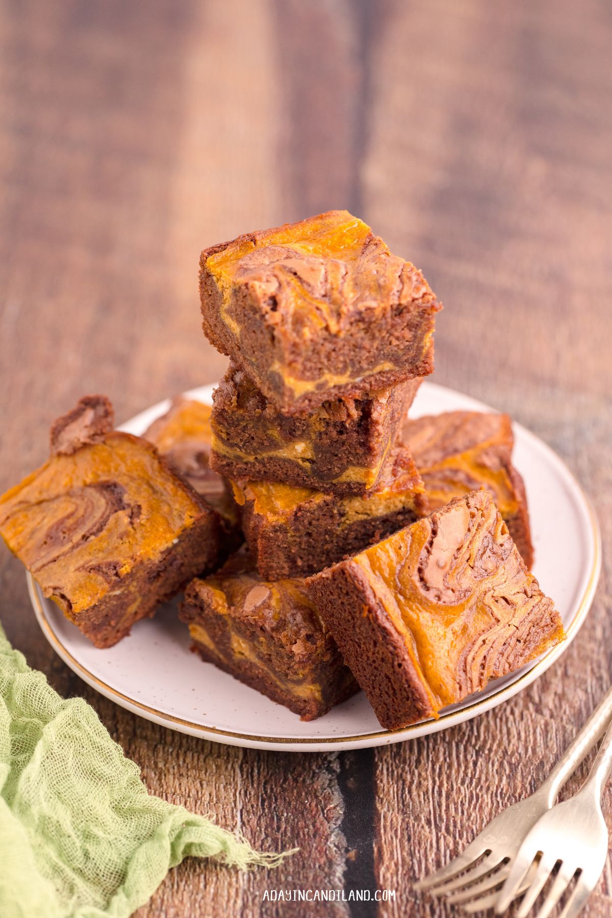 White Plate of stacked brownies. 