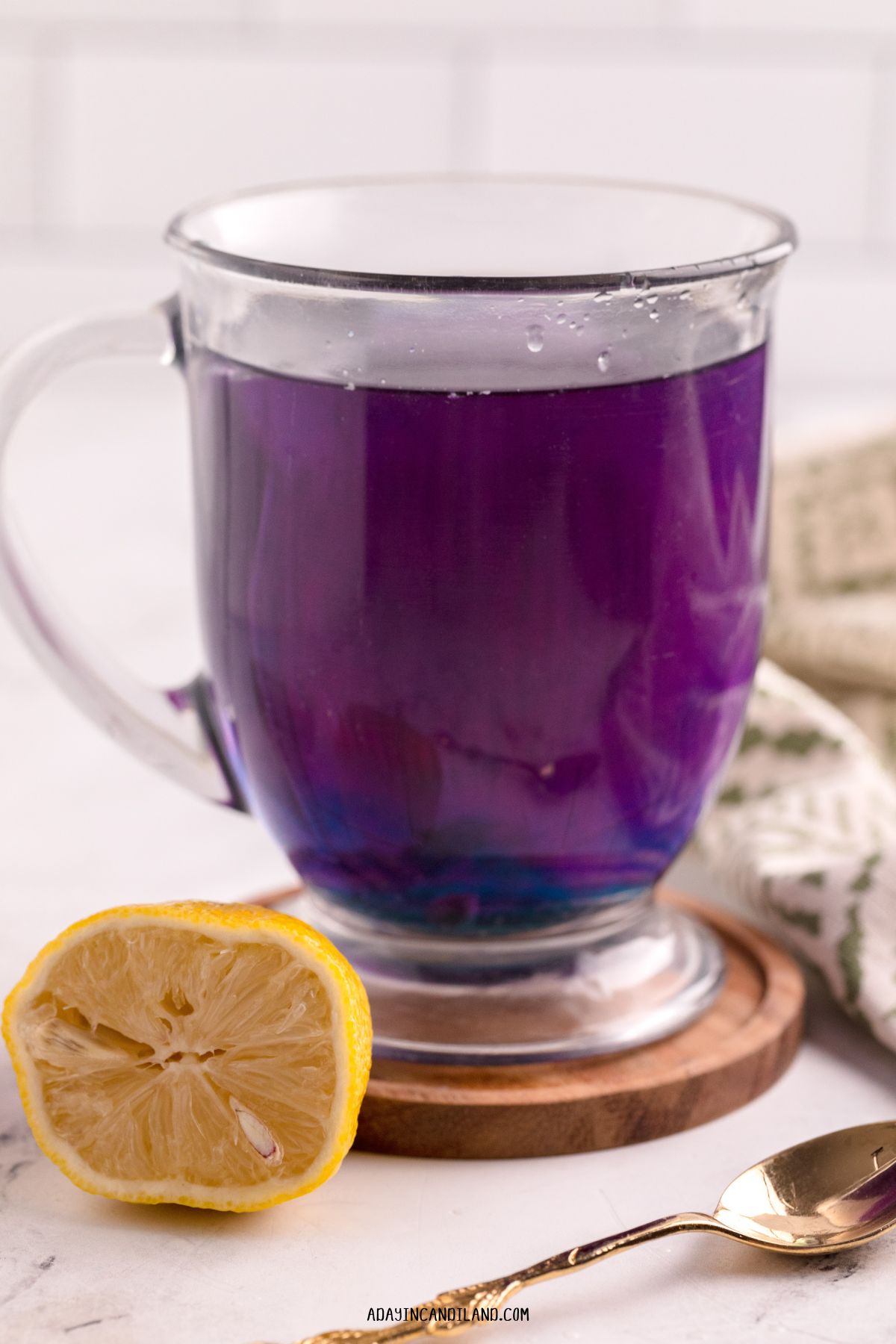 Glass of Butterfly Tea made with a tea bomb. 