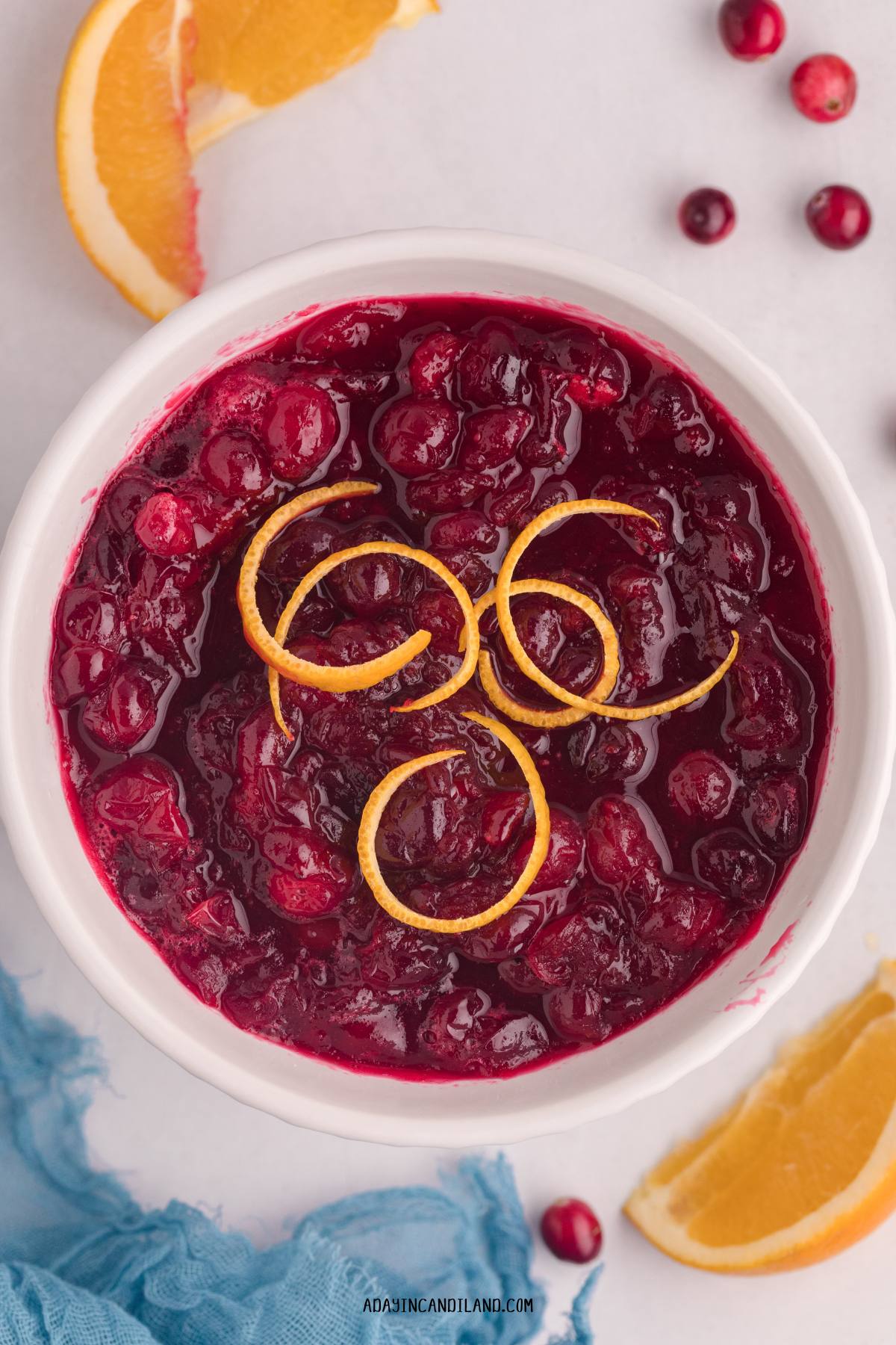 Bowl of Cranberry Sauce with orange zest on top. 