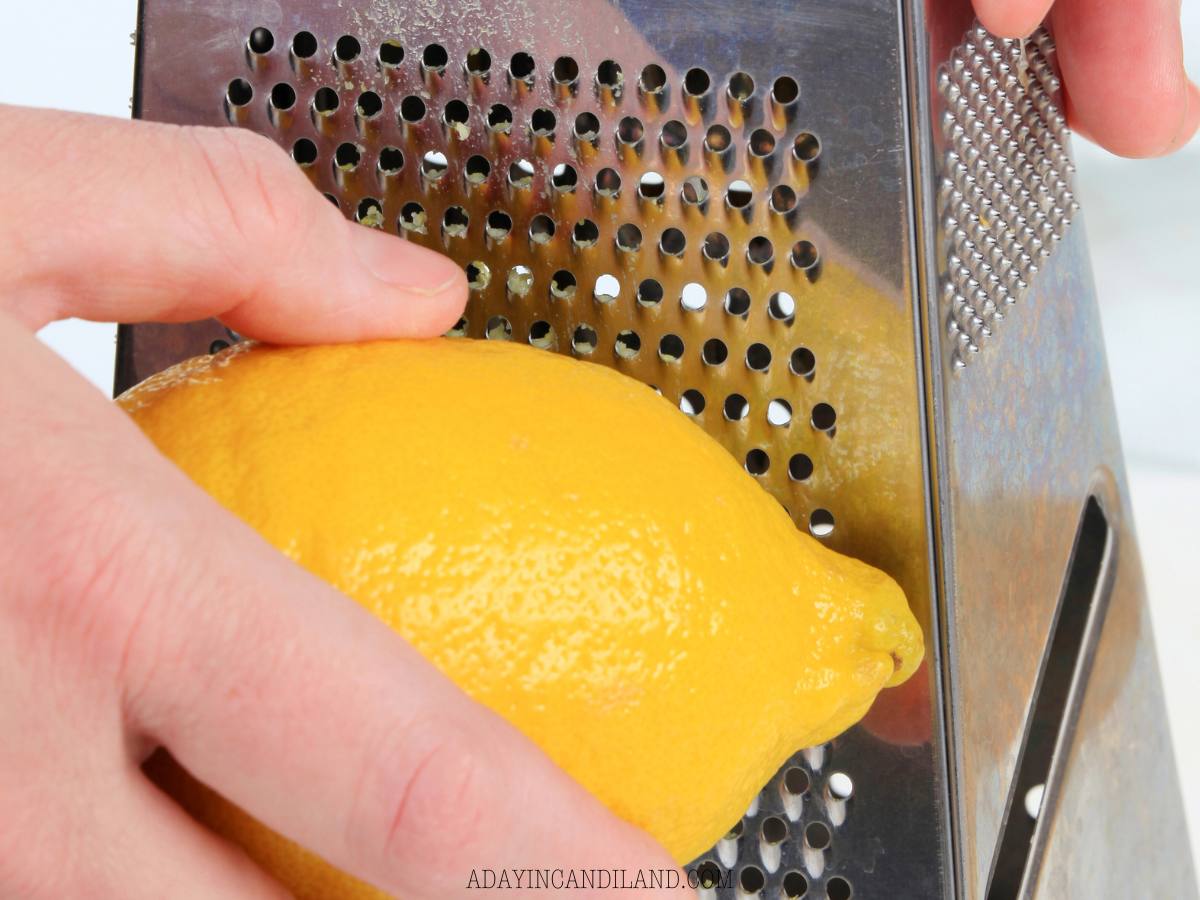 Zesting a lemon with a box grater. 