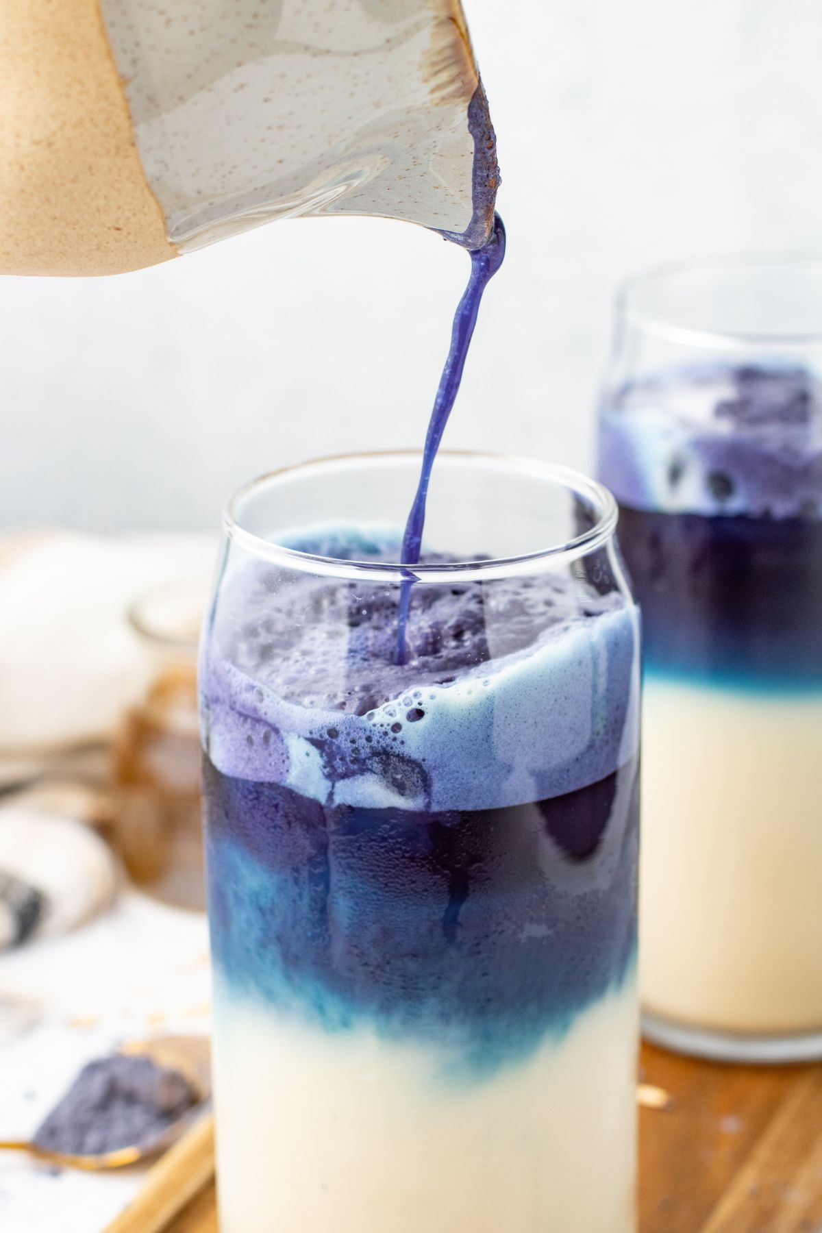 Pour shot of Iced Blue Butterfly Latte. 