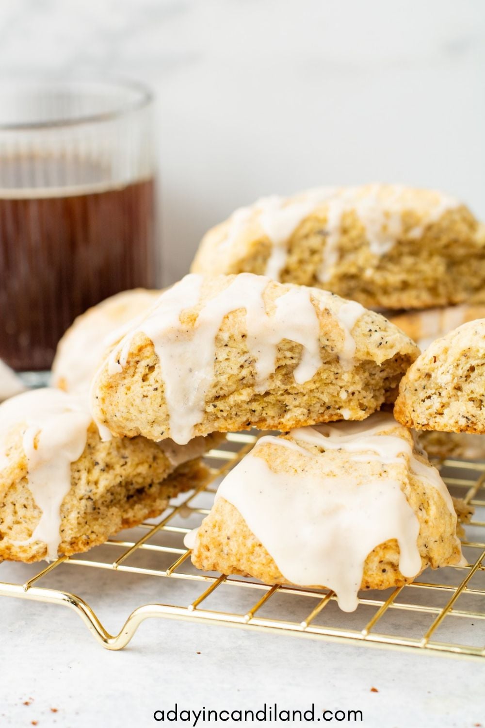 Earl Grey Scones with Drizzle on a rack with a cup of hot tea.