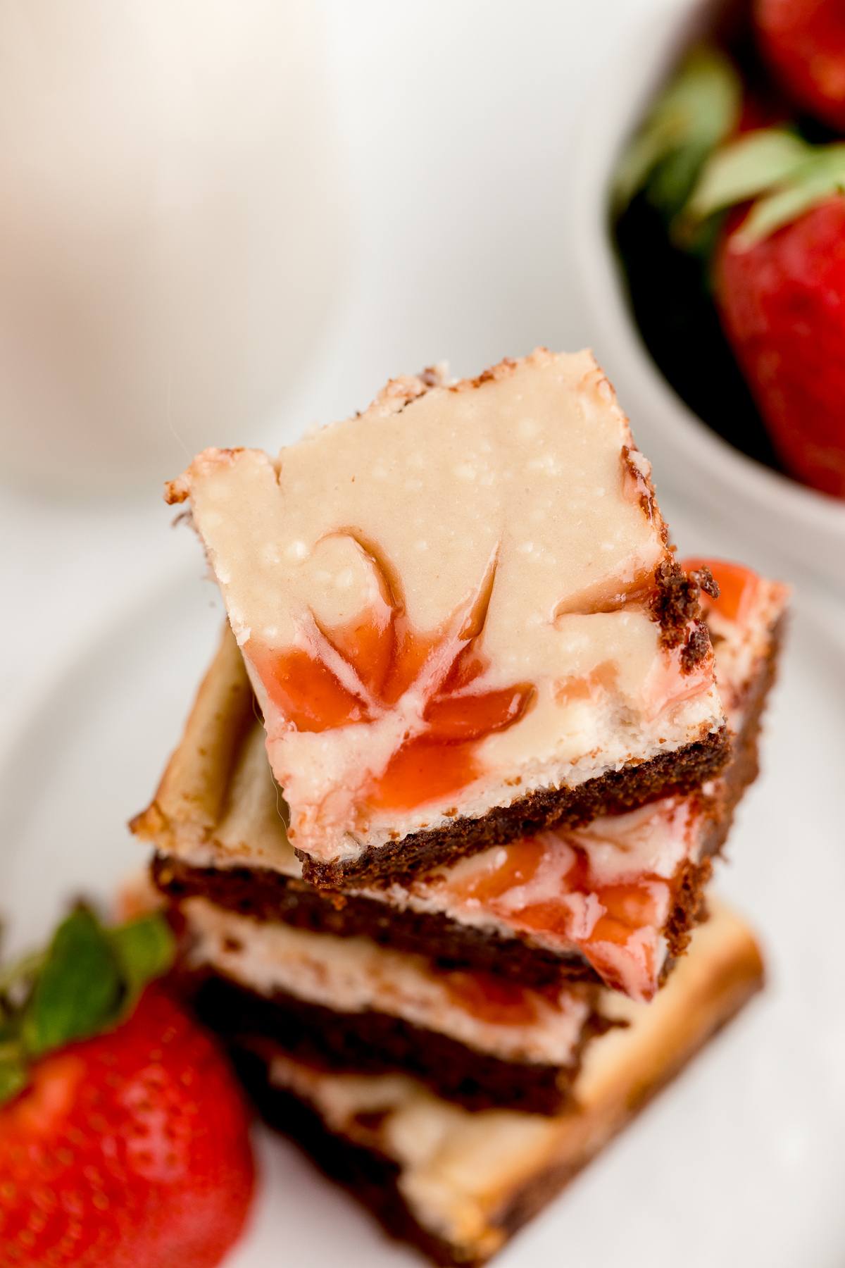 Plate of stacked Strawberry Cream cheese swirl brownies. 