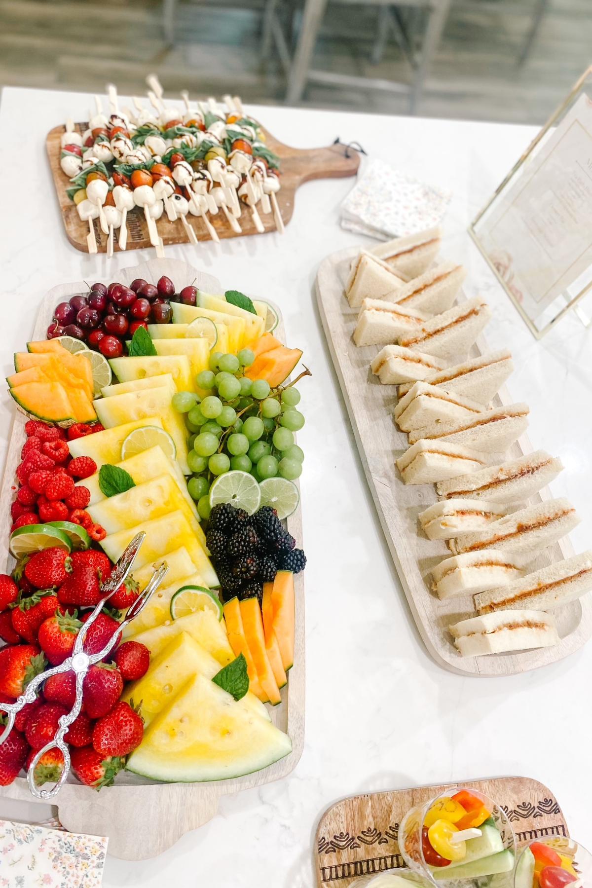 Sandwiches, fruit and skewers for a tea party.