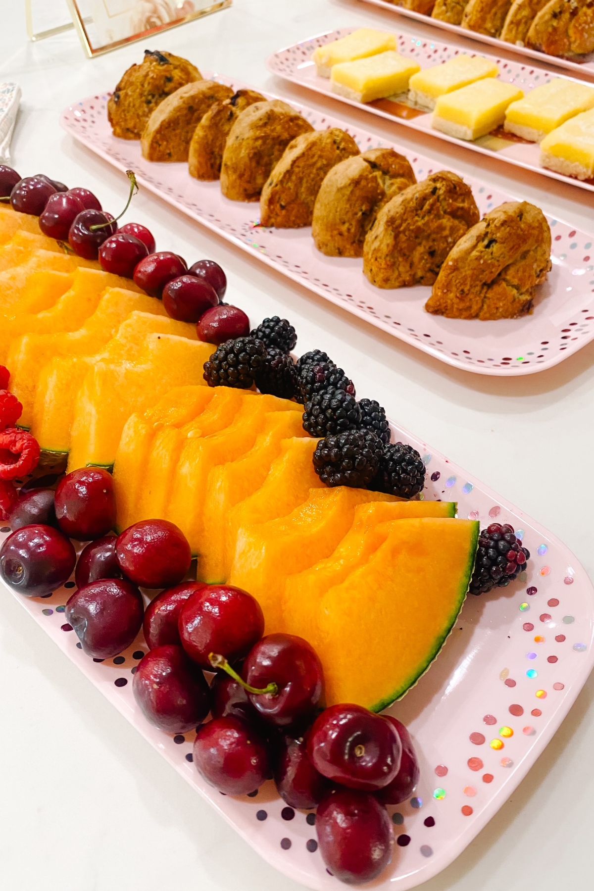 Lemon bars, fruit and biscuits for tea party. 