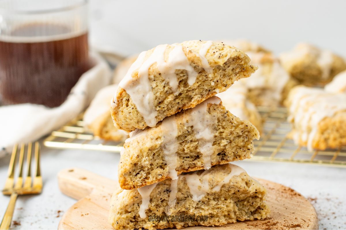 Stack of 3 Earl Grey Scones with a cup of tea in the corner.