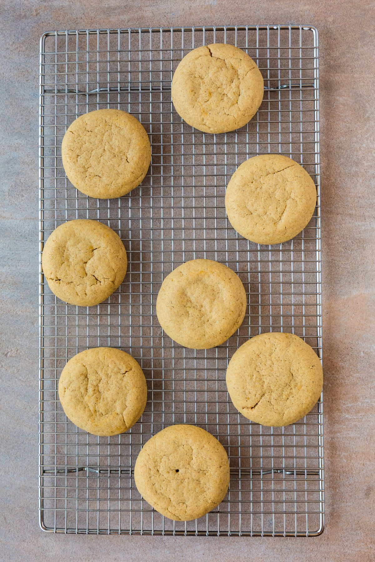 Baked pumpkin cookies cooling unfrosted on a wire rack.