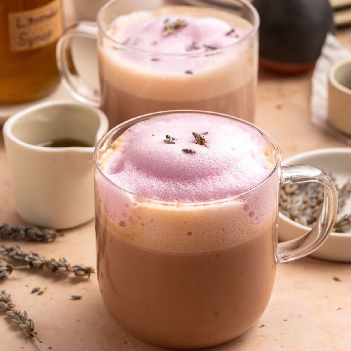 2 Glass mugs of lavender lattes with simple syrup. 