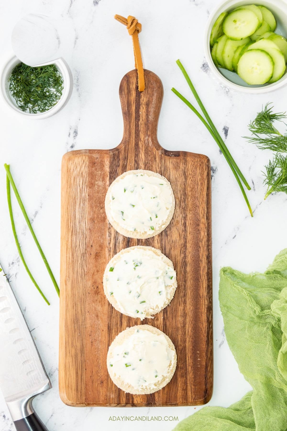 Cream cheese mixed with chopped chives spread over the buttered bread rounds.