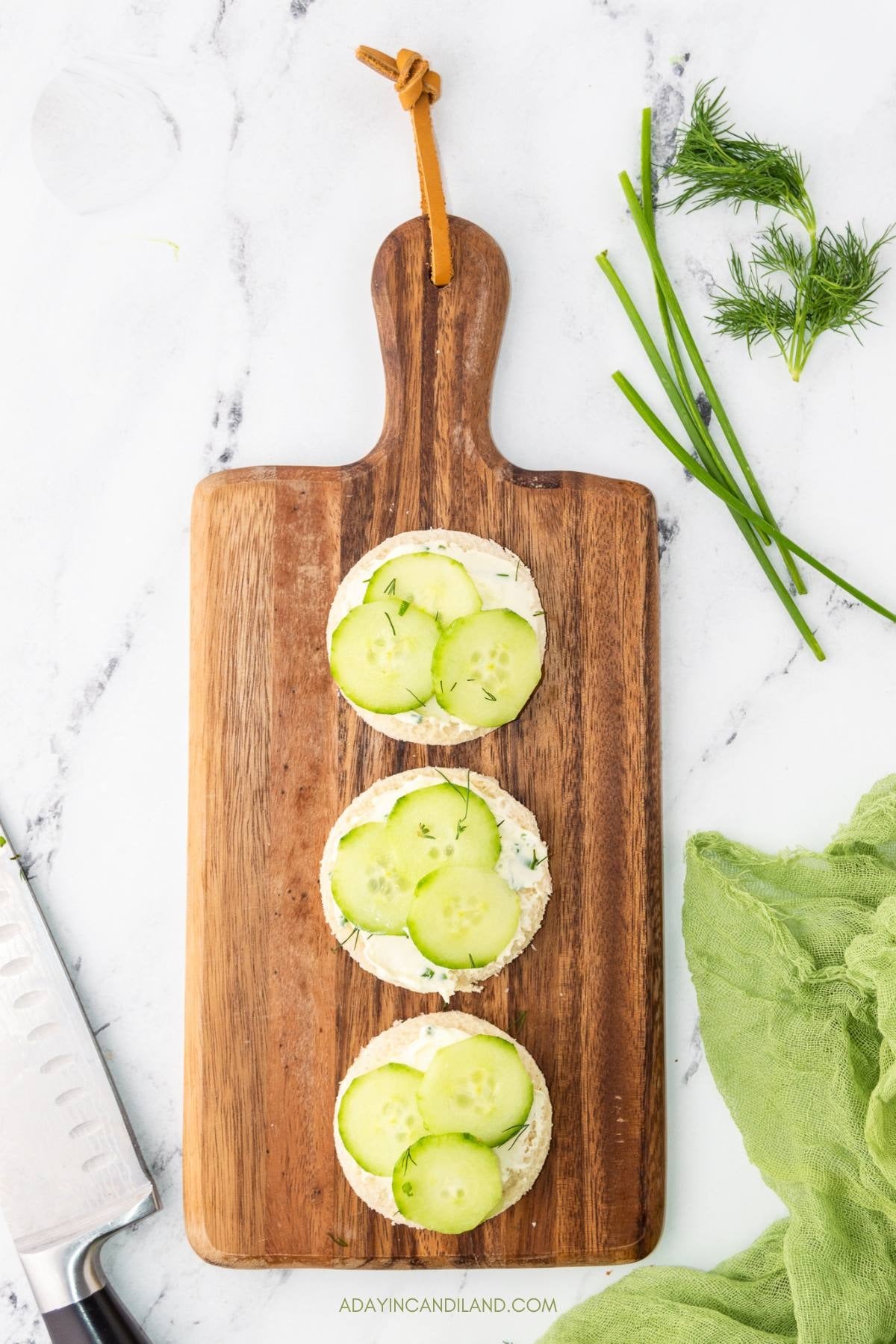 Thin cucumber slices layered onto the cream cheese rounds.