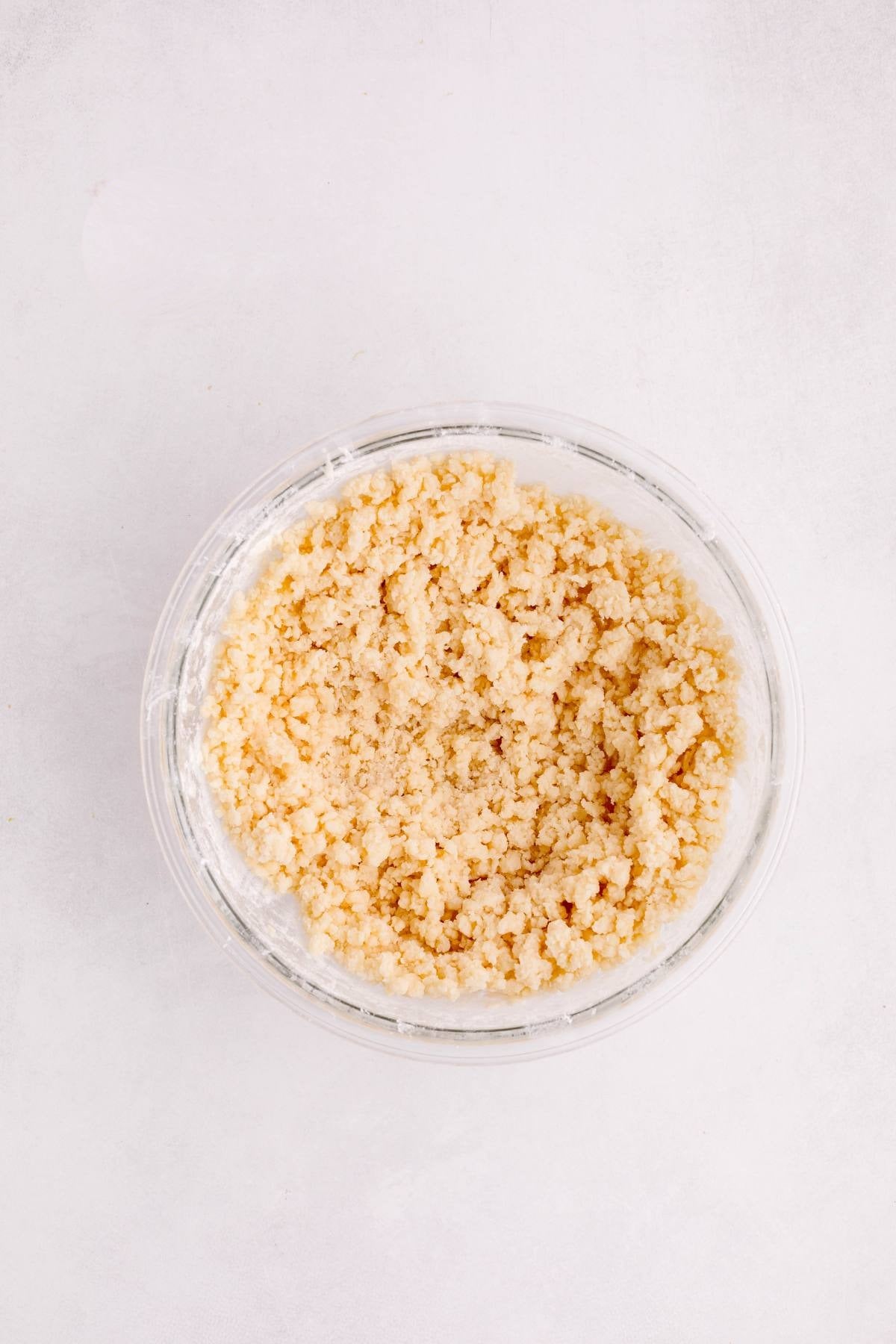 Crumbly shortbread crust dough after adding flour and salt.