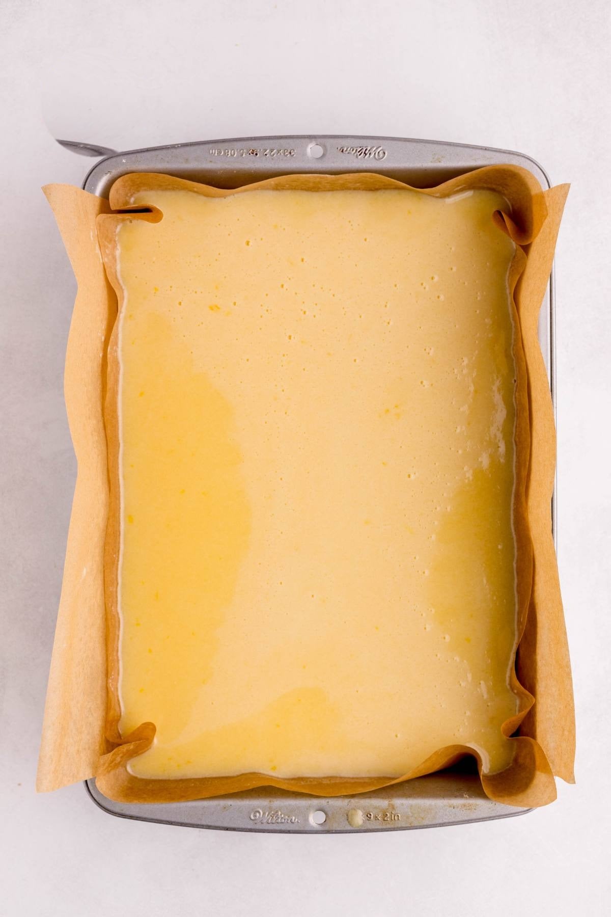 Lemon filling poured over the warm baked crust in the pan.