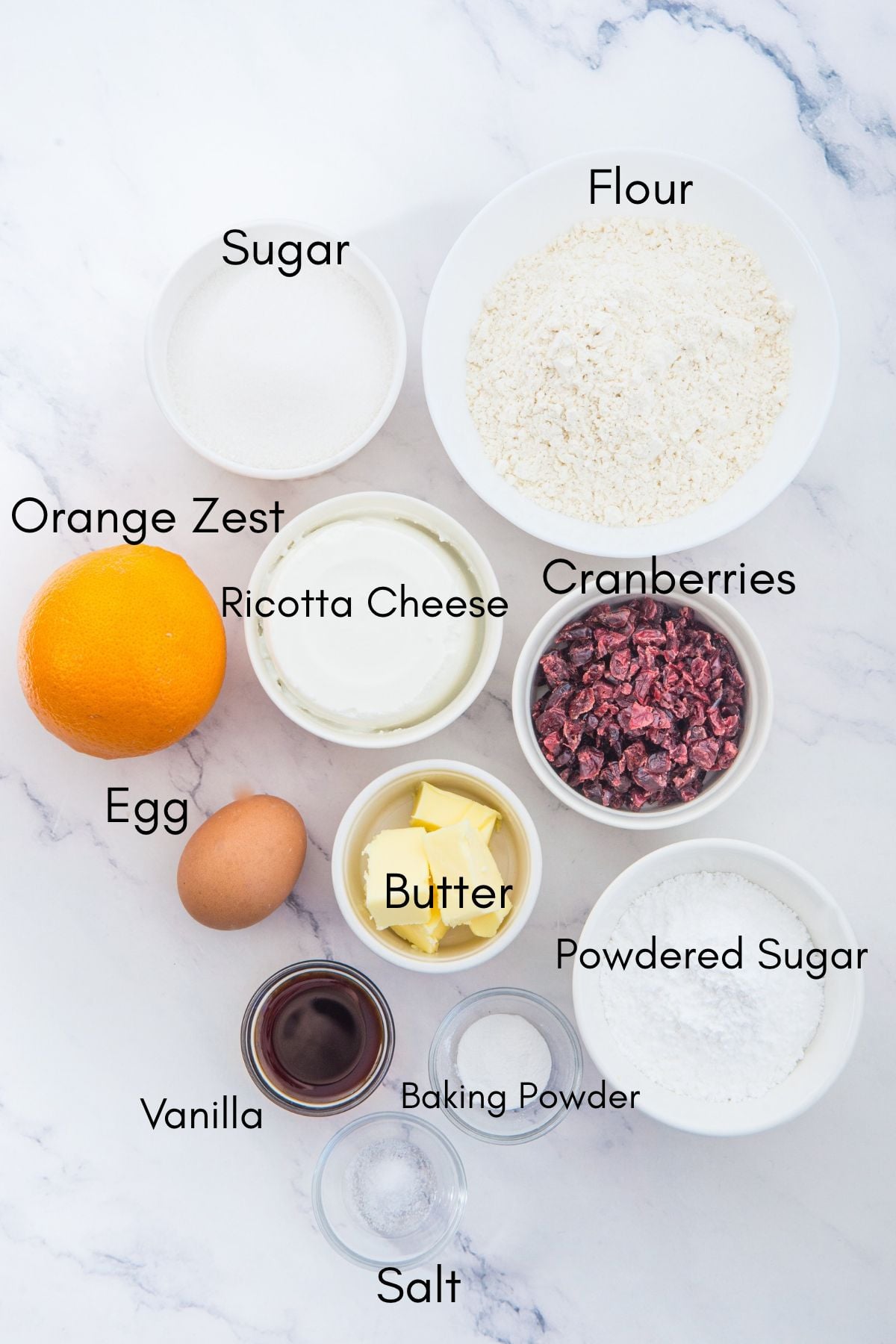 Ingredients for cranberry orange ricotta cookies arranged in small bowls
