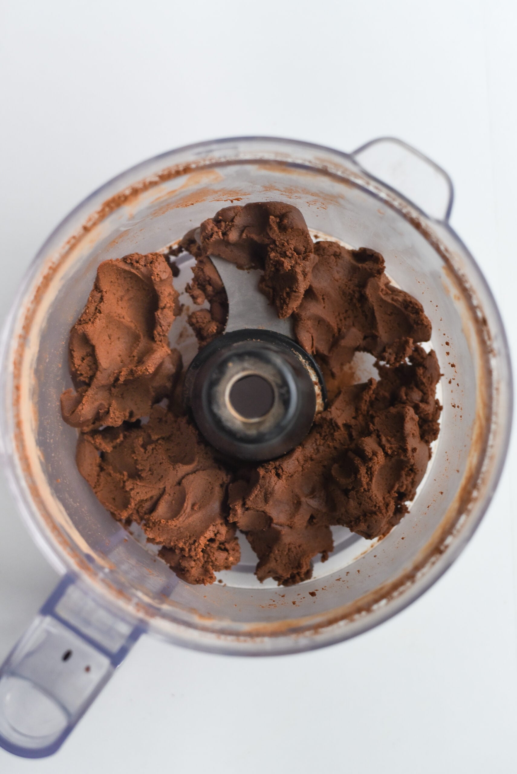 Cocoa powder and flour in a food processing bowl.
