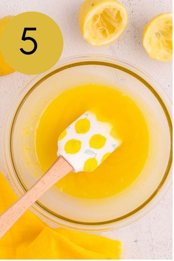 Lemon zest stirred into the strained lemon curd with a spatula.