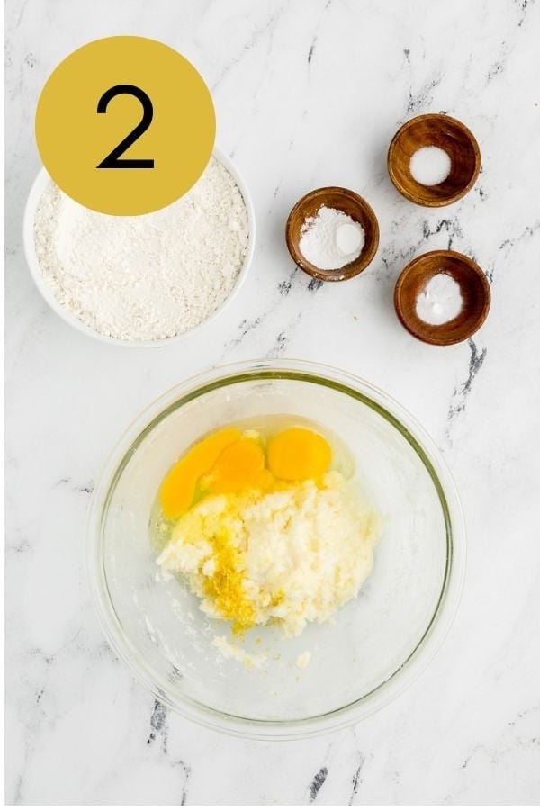 Eggs and lemon zest added to the creamed butter and sugar.